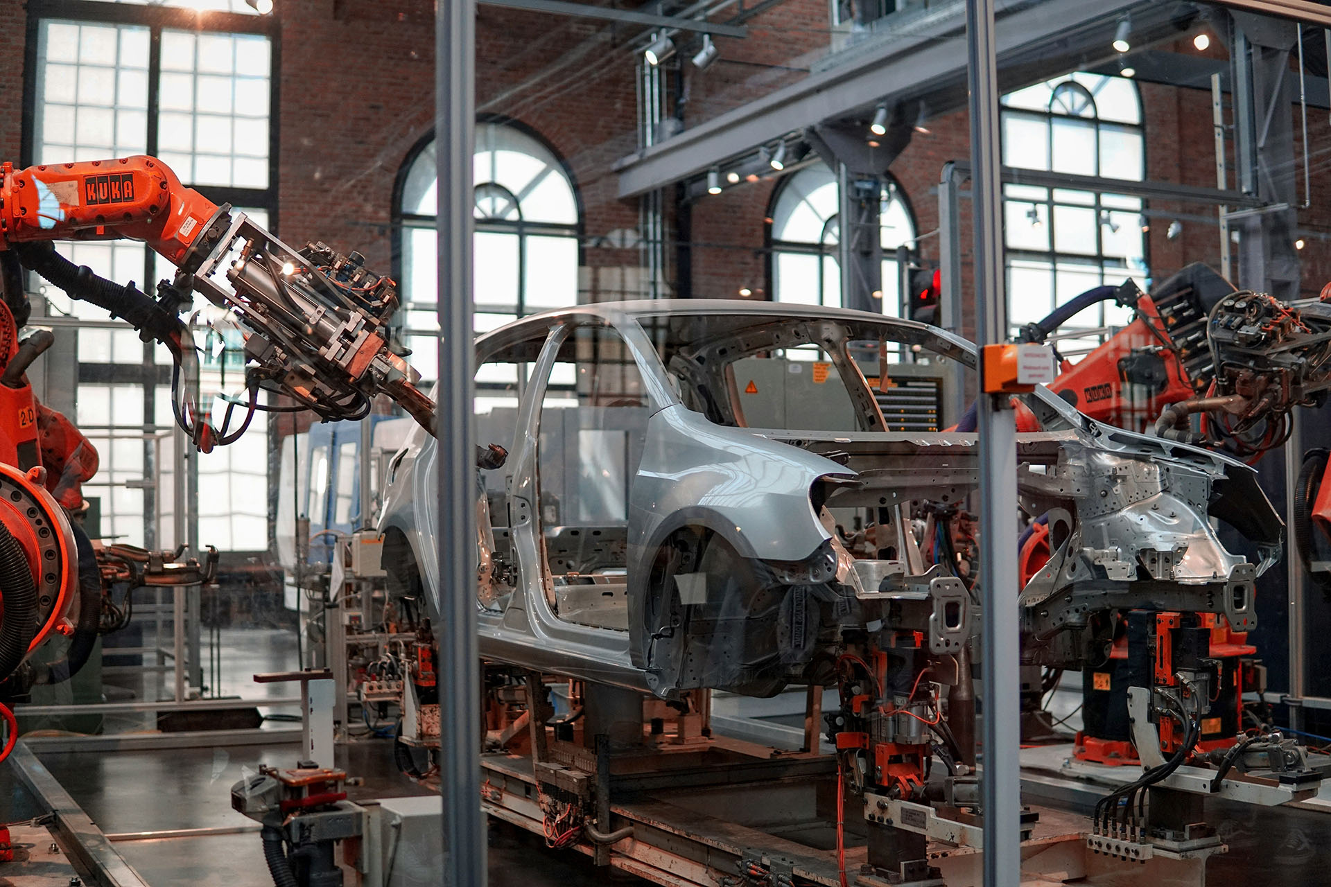 Robots work on a car in a production line.