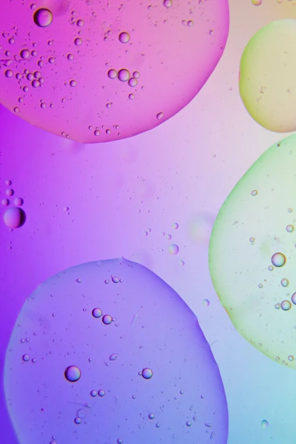 A slide depicting water droplets under different coloured lights.