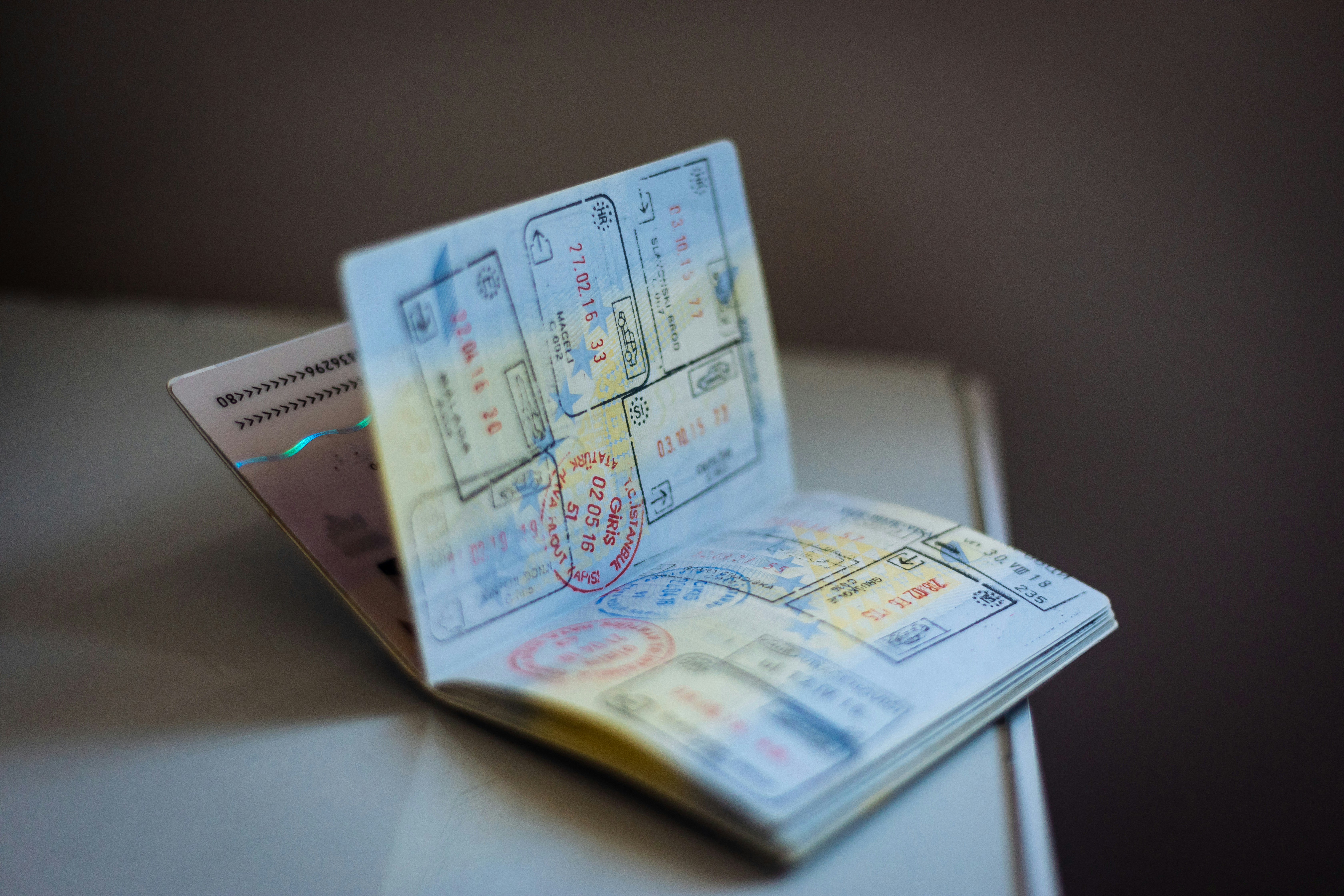 An open passport revealing many different stamps on its pages.