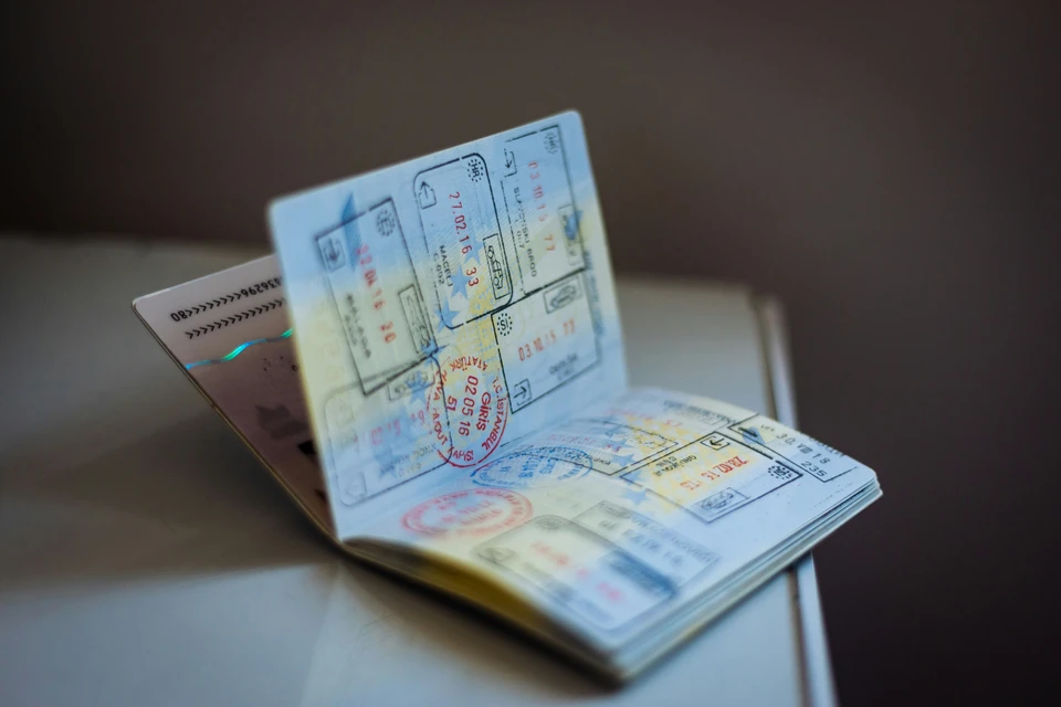 An open passport revealing many different stamps on its pages.