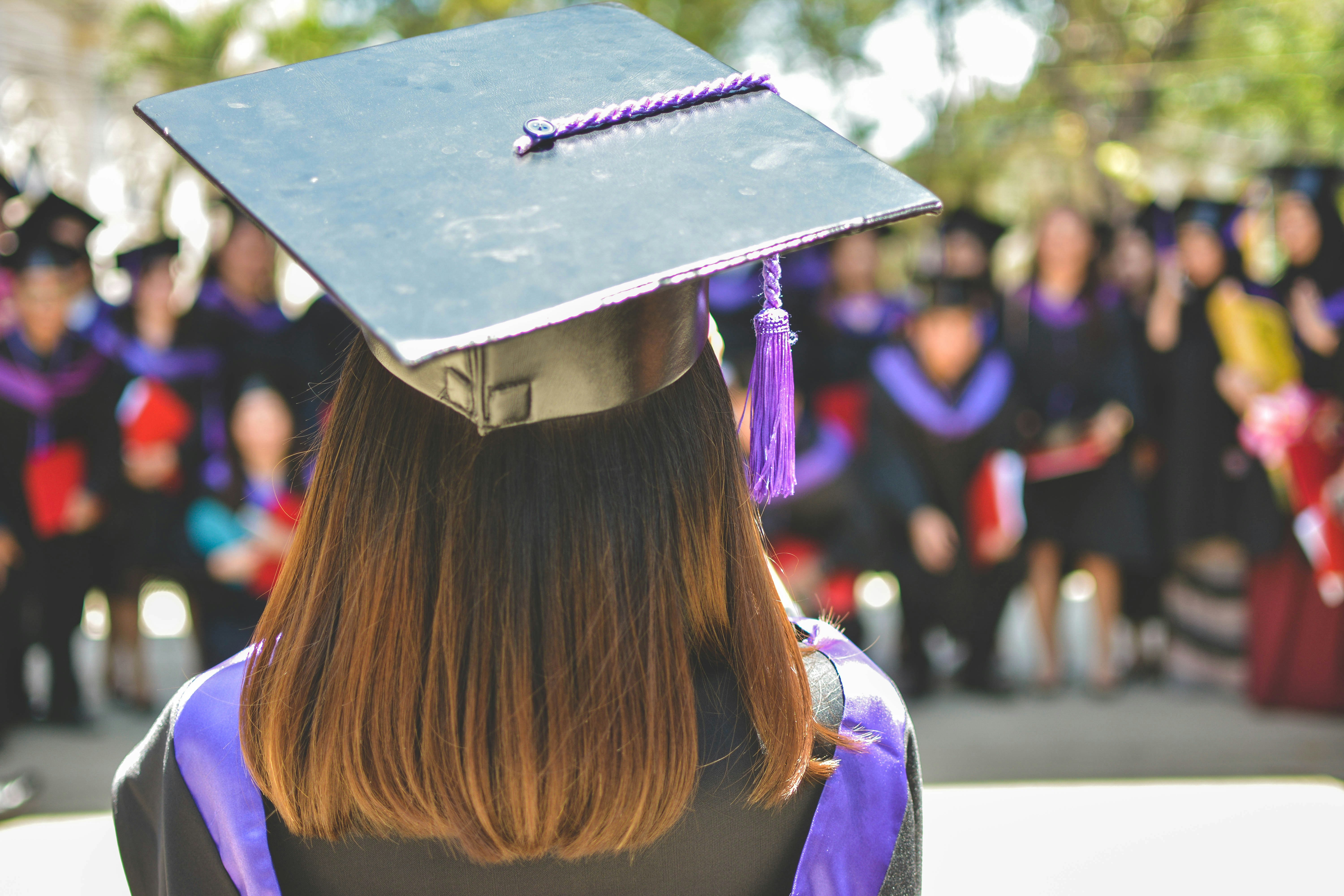 A shot from behind of a graduate wearing their mortar board.