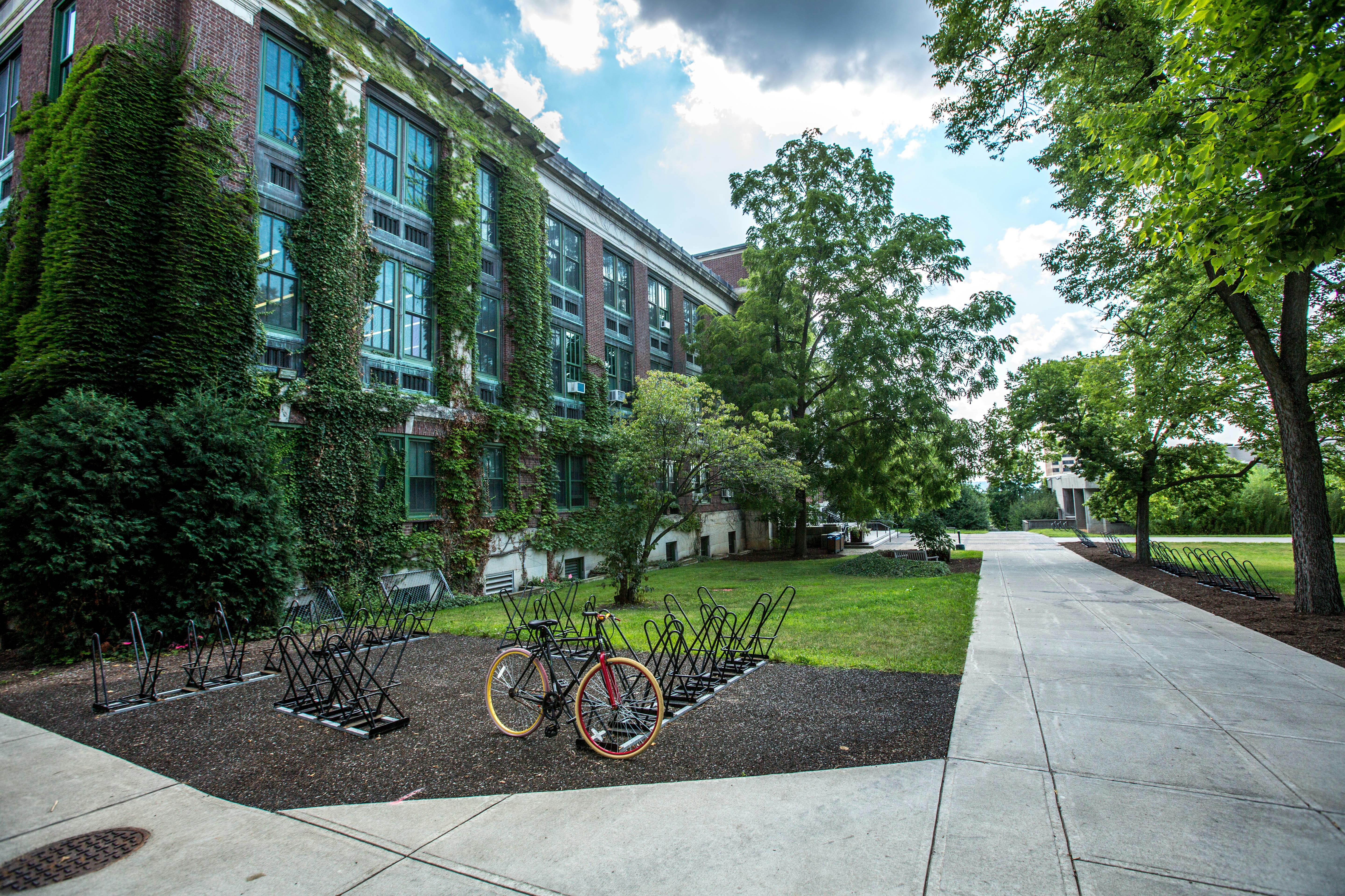 An exterior of student accommodation with a lone bicycle in a rack outside.