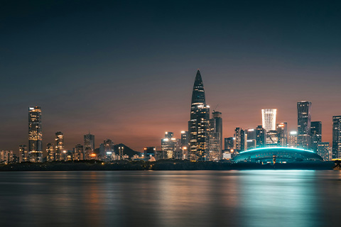A brightly lit city skyline at night.