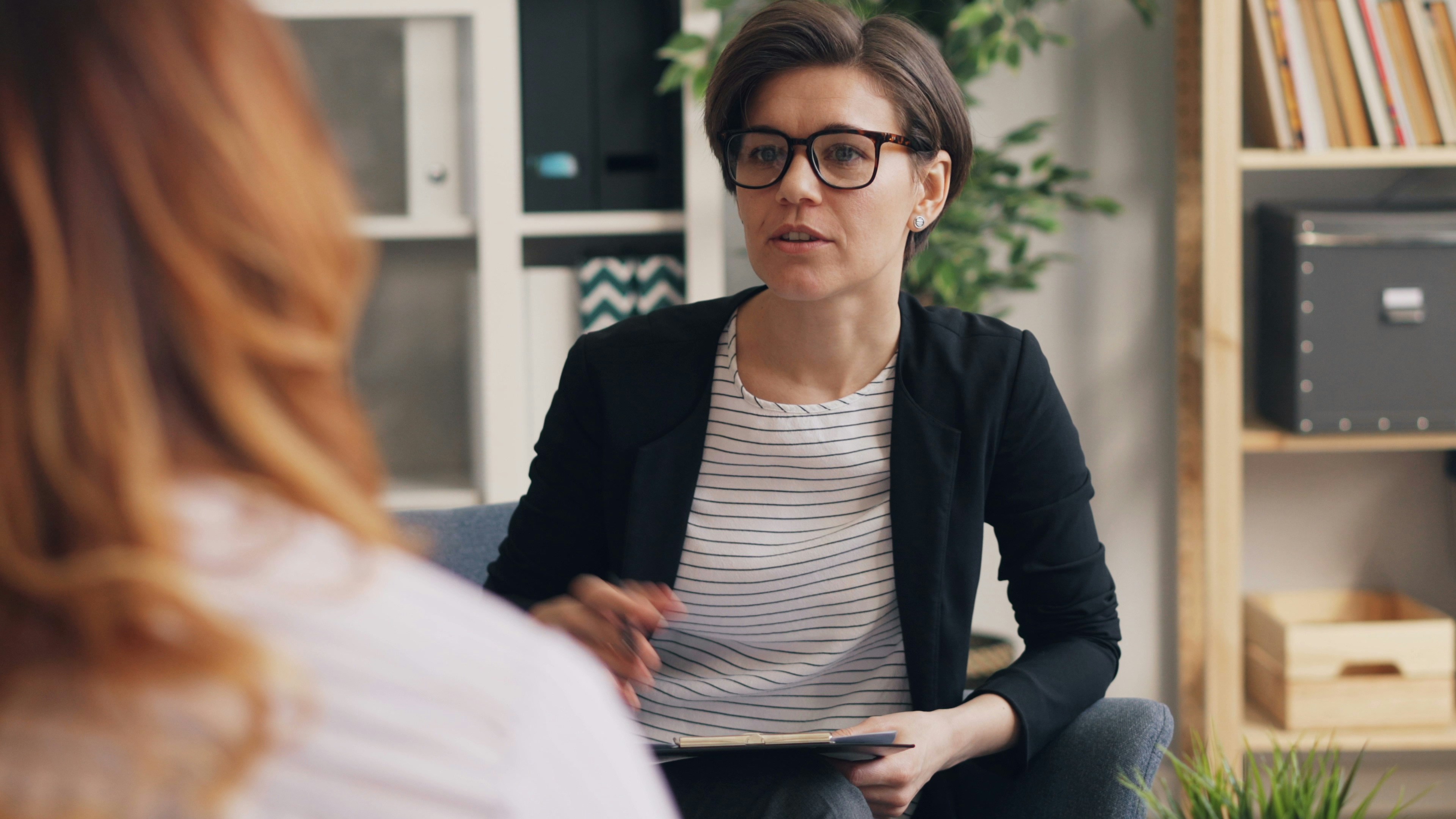 A counsellor talks to a student in a private space.