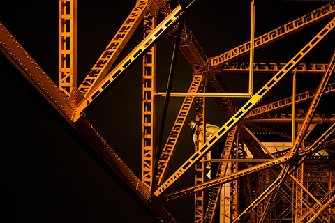 Struts from an engineering structure lit at night.